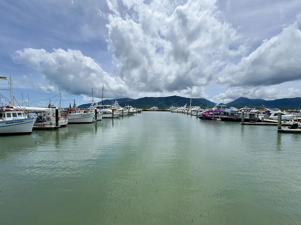 Looking down a fairway of Cairns Marlin Marina towards the ranges (2025)