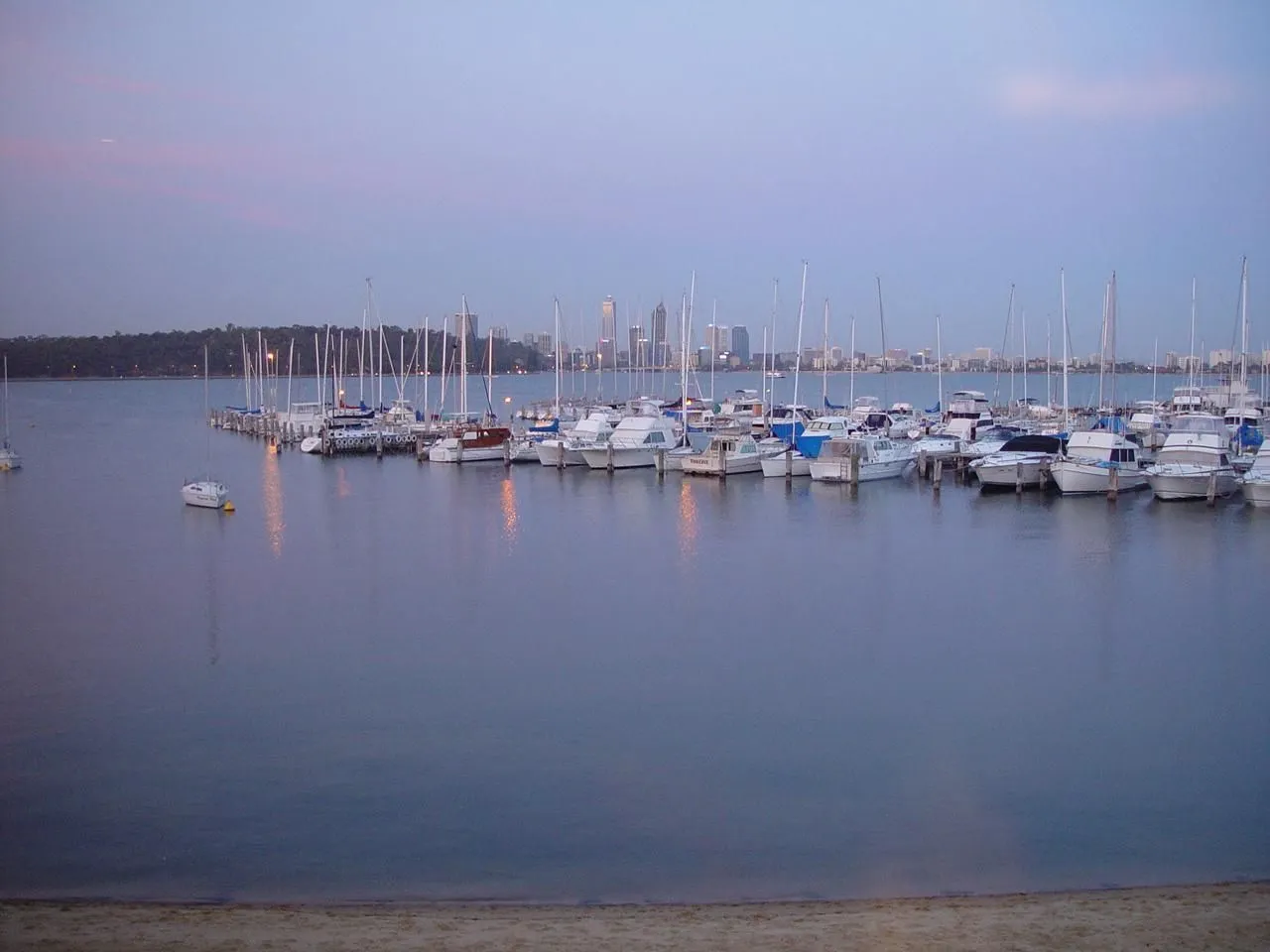 Boats moored at Royal Perth Yacht Club, Perth city skyline behind