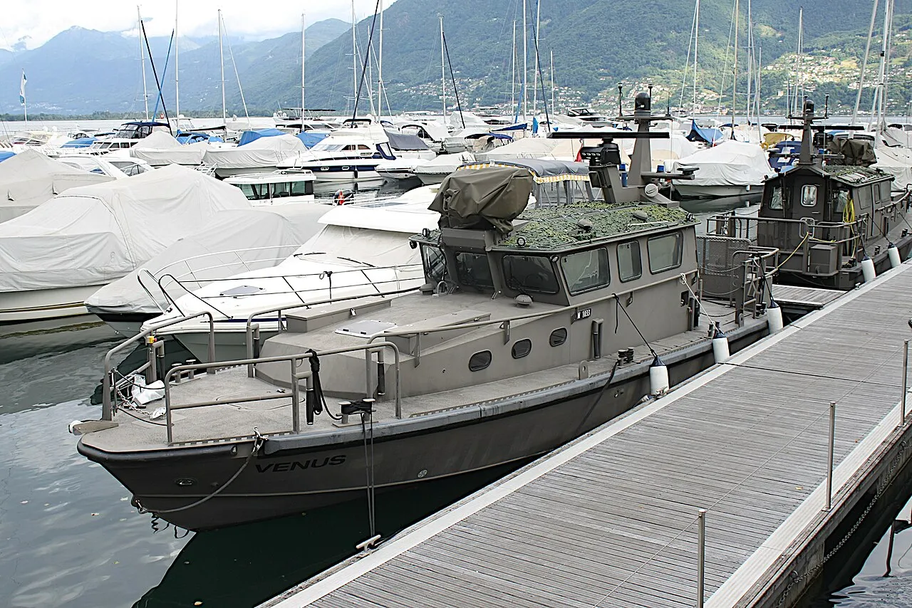 The patrol boat Venus and yachts on a pontoon in Locarno marina