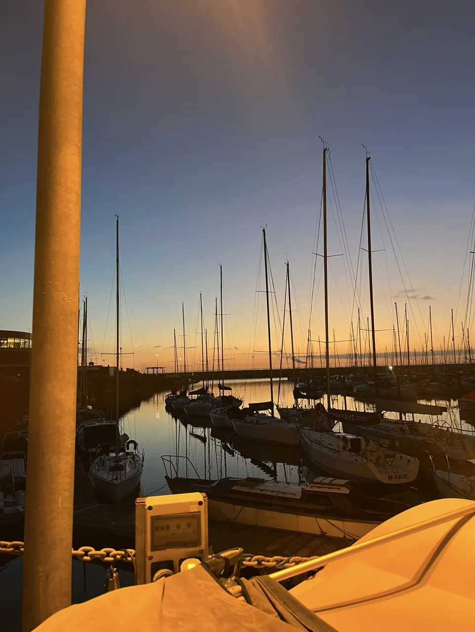 Yachts on the Royal Irish Yacht Club pontoons at dusk, Dún Laoghaire Harbour (cropped)